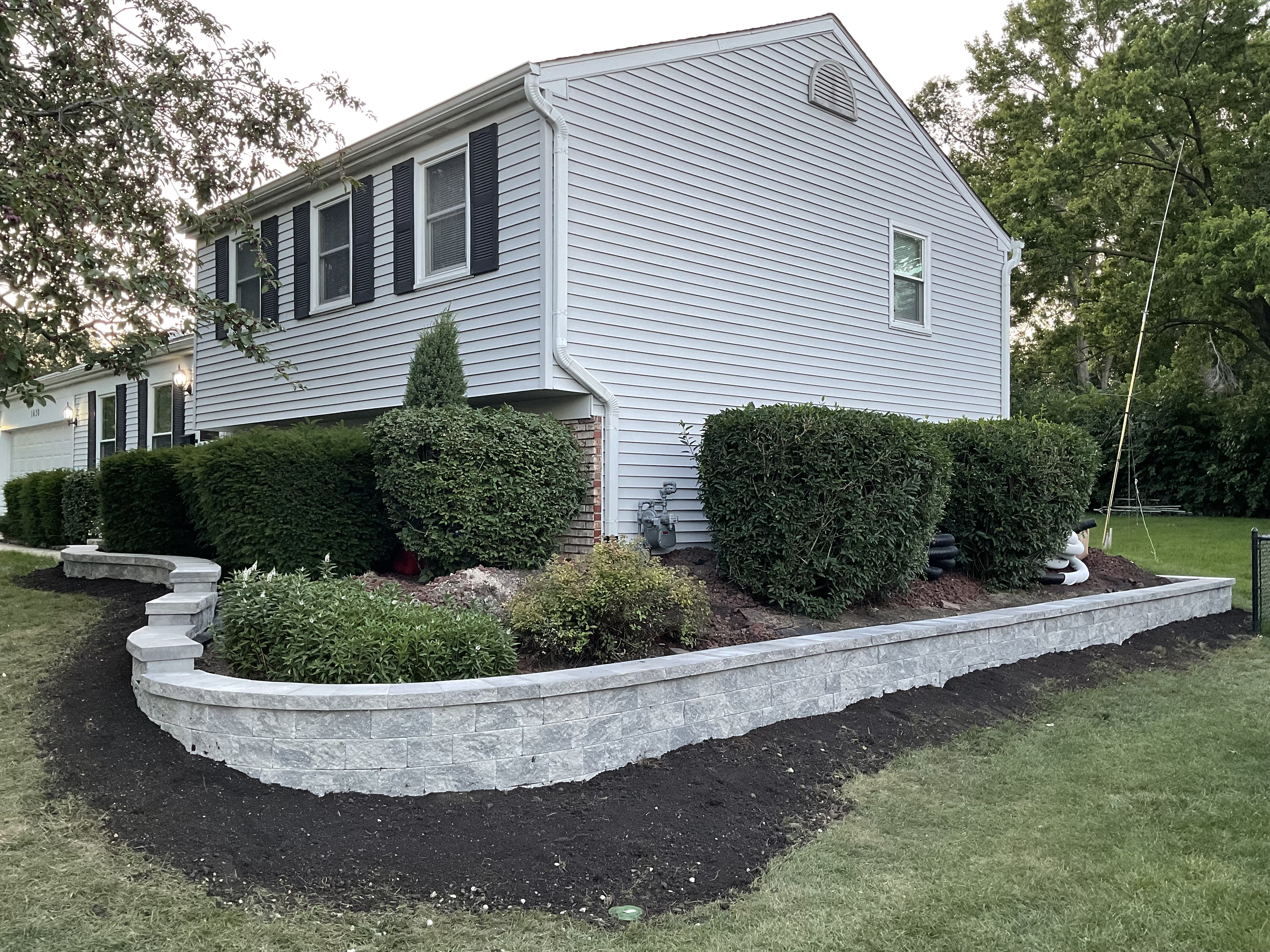 Transforming Landscapes: The Artistry of Mission Brick Paving's Curved Retaining Wall in Naperville, Illinois Thumbnail